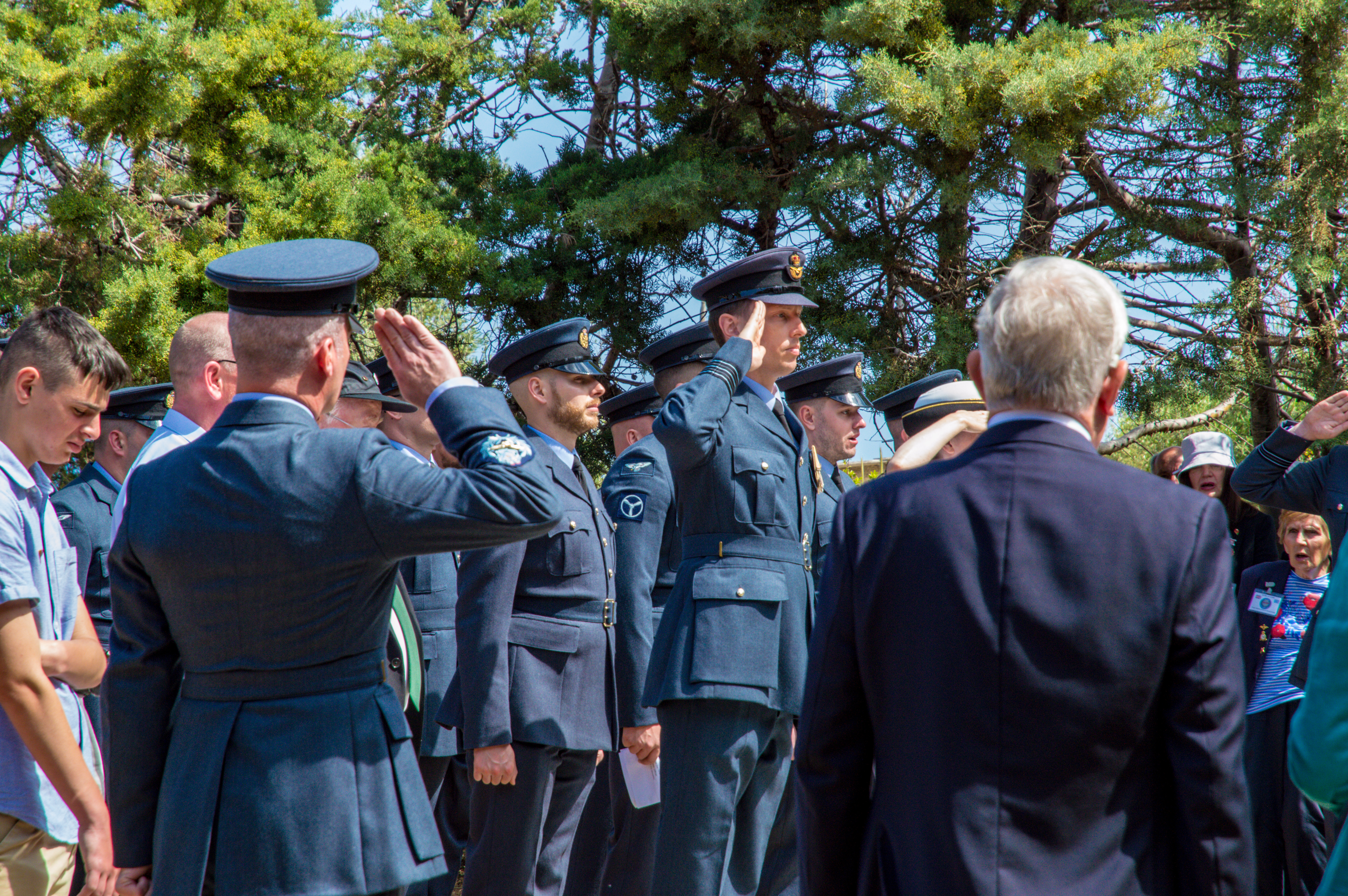 Personnel salute with members of the public.